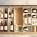 Open vanity drawer beautifully organized with skincare bottles in aesthetic dividers.