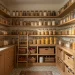 Beautifully organized pantry with fluted glass jars on oak wood shelves